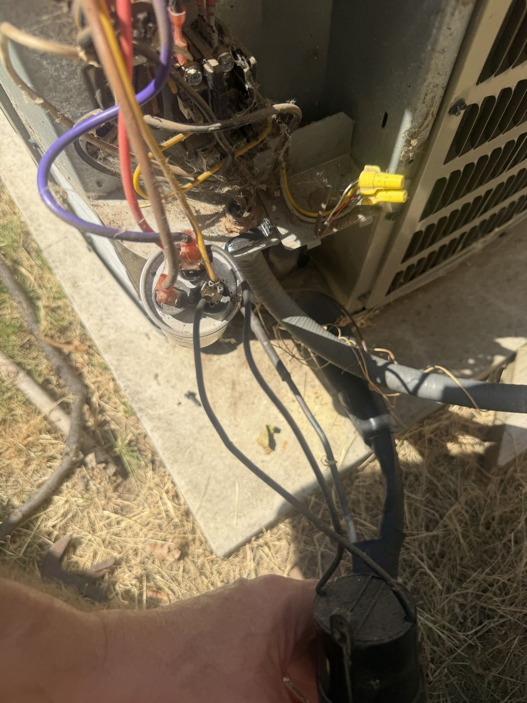 The old dual run capacitor with a blue hard start kit piggybacked onto it