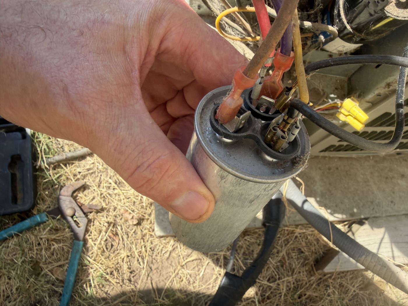 Looking down at the three terminals on top of the capacitor, marked C, FAN and HERM