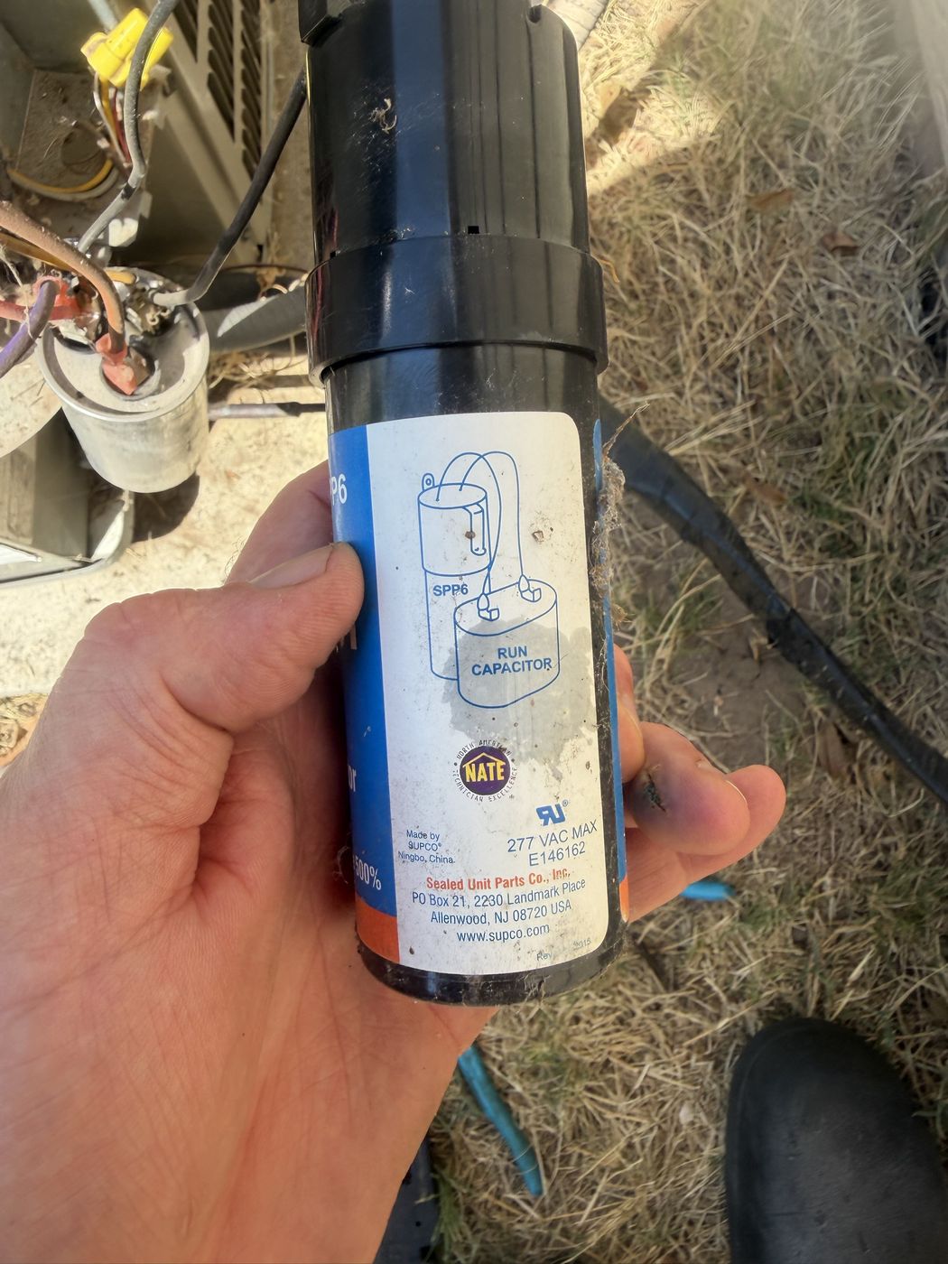 The blue SPP6 hard start kit removed from the unit