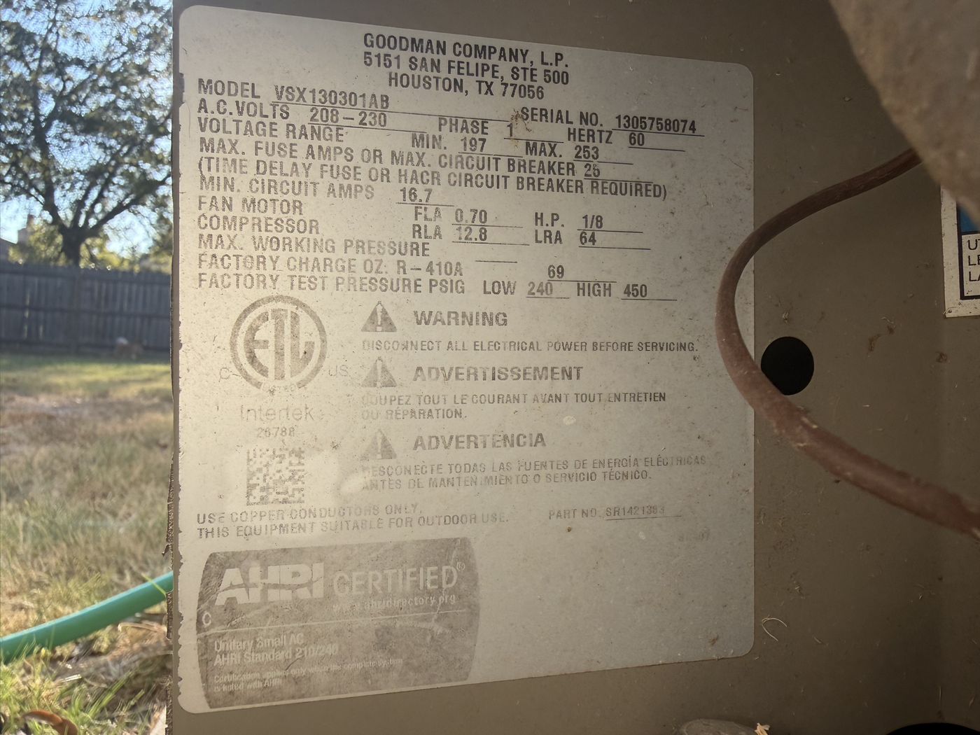 The model and serial data plate on the side of the condenser unit
