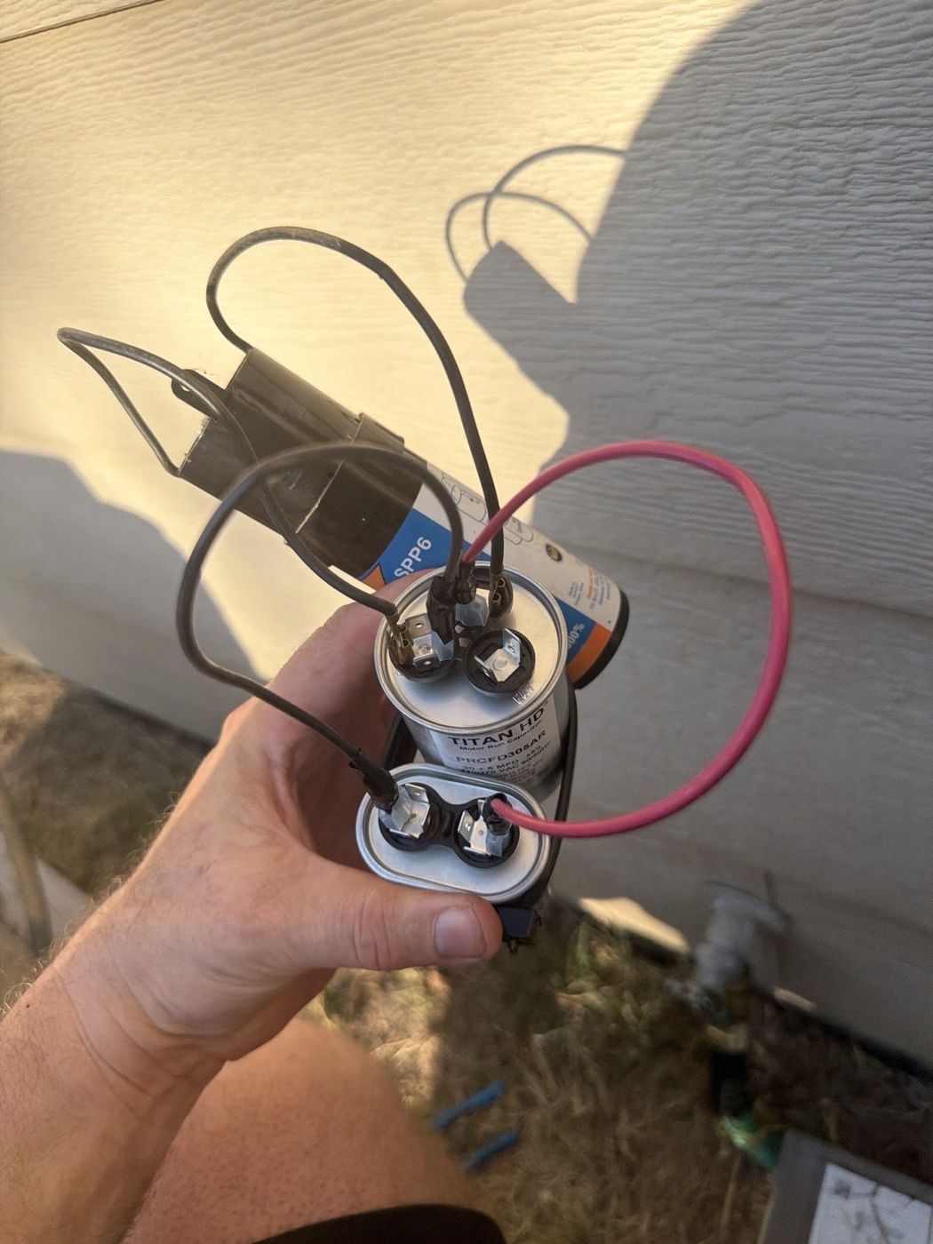 The finished capacitor stack installed with the original hard start kit back in the loop
